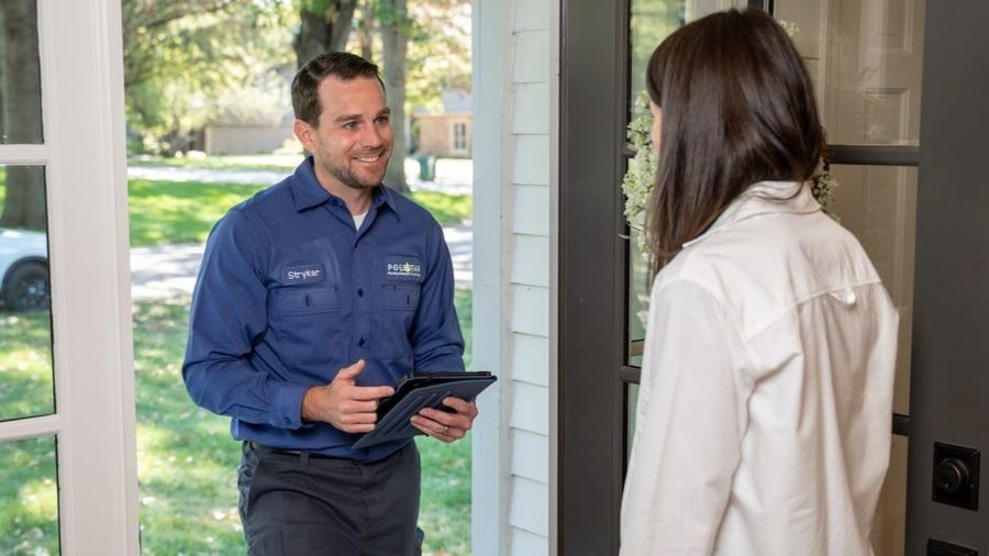 Polestar tech greeting client at the door with iPad.