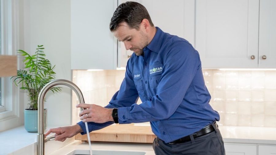 Plumber testing out leaking faucet.