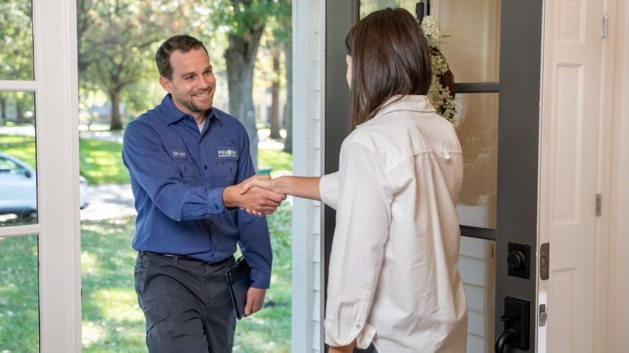 Polestar plumber greeting client at the door.